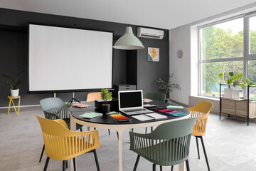 Interior of conference room with table and projector screen