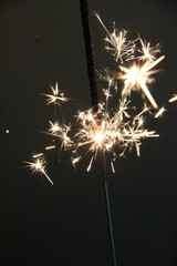 Sparkling celebration with a handheld sparkler illuminating the night during a festive gathering