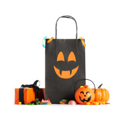 Black shopping bag with gift box, candies and Halloween decorations isolated on white background