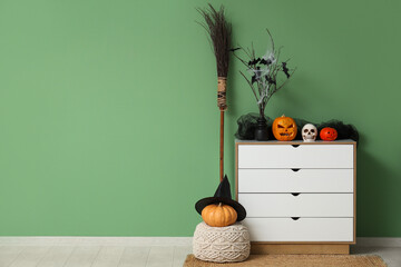 Interior of room decorated for Halloween with commode, pouf and pumpkins