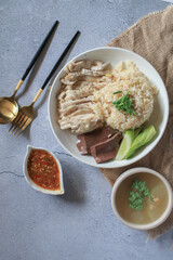 Rice steamed with chicken soup and dipping sauce or Khao Mun Kai in white plate. thai food concept.