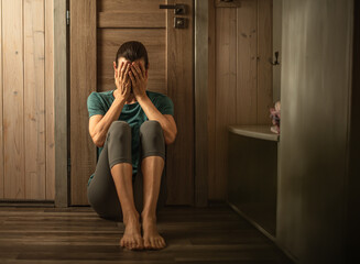sad unhappy woman in her bedroom suffering from depression, stress, mental health issues 