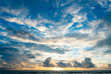 Ocean panorama. Dark orange clouds day to night sky. Dramatic sunset over storm clouds. Beautiful red color sky. Red purple orange blue pink sunset cloud background. Concept holiday in the tropics