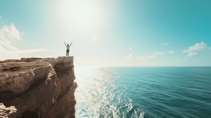 person standing with their arms open wide on the edge of a cliff