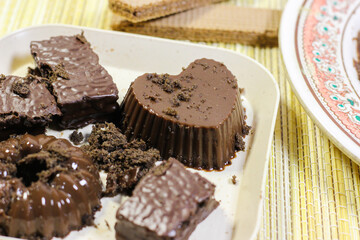 Chocolate pudding on white plate with woven tablecloth isolated