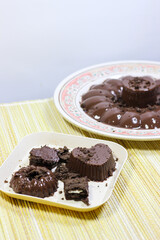 Chocolate pudding on white plate with woven tablecloth isolated