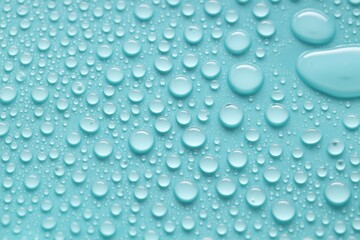 Water drops on turquoise background, above view