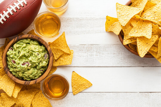 Delicious Super Bowl party food spread featuring guacamole, tortilla chips, and drinks, perfect for game day celebrations!