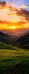 A beautiful sunset over a grassy hillside. The sky is filled with clouds and the sun is setting, casting a warm glow over the landscape. The scene is peaceful and serene