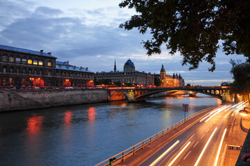 Paris, Ille de France, France. September 16, 2024: Evening view of the Seine River with light trails and historic buildings in Paris, France
