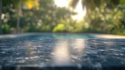 Fototapeta premium A blurred view of a poolside with a marble surface in focus, creating a serene atmosphere.