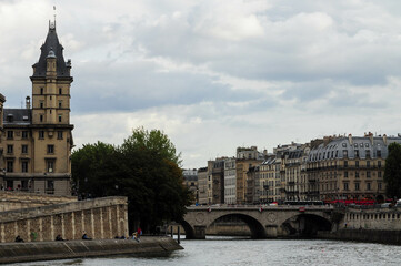 Paris, Ille de France, France. September 16, 2024: Cloudy day in Paris with the Seine River and historic buildings.