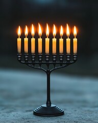 Fototapeta premium A traditional menorah with nine lit candles, glowing against a dark background.