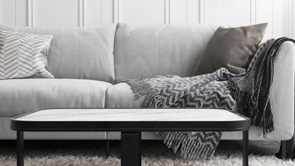 Close up of white rectangle marble coffee table, gray sofa, cushion, shag rug in luxury, modern...