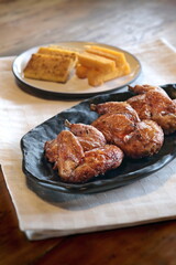 pieces of roast chicken, known in Brazil as galeto, on a plate with fried polenta