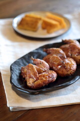 pieces of roast chicken, known in Brazil as galeto, on a plate with fried polenta