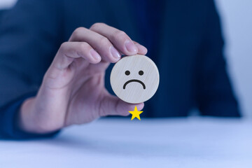 Businessman selects unhappy angry face from emotion block. Customer feedback, bad experience,...