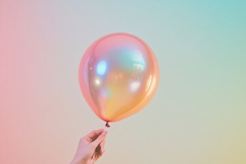 Elegant Hand Holding Single Iridescent Balloon Against Dark Background - High-Contrast Minimalist