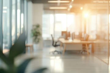 Fototapeta premium A blurred view of a modern office space with natural light and greenery.