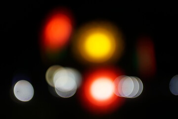 Blurred city lights at night, creating a colorful bokeh effect. Urban night scene concept