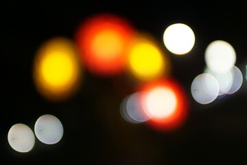 Blurred city lights at night, creating a colorful bokeh effect. Urban night scene concept