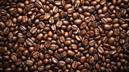 Fototapeta premium 26. Dense background filled with an abundance of roasted coffee beans, creating a rich and textured visual with a uniform brown hue