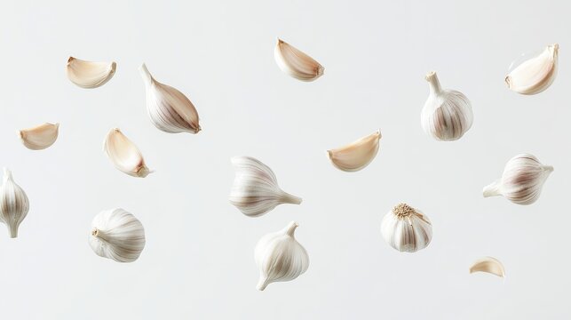 157. Floating garlic cloves isolated on a white background, with varying angles and positions creating a sense of movement and texture