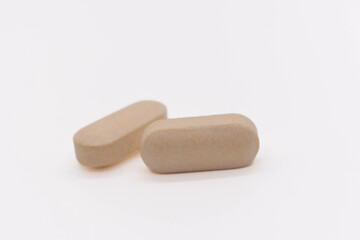 medicinal vitamin tablets isolated on white background, copy space, selective focus