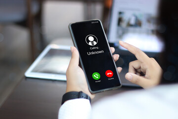 Unknown number displayed showing on smart mobile phone. Human use smartphone with incoming call...