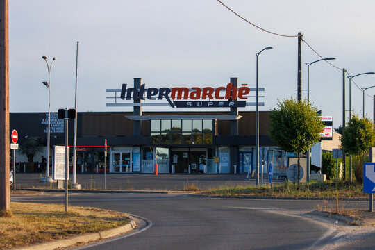 France, 10 August 2024: Intermarche supermarket exterior at sunset with empty parking lot.