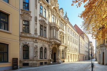 Obraz premium A historic building with ornate architecture on a quiet street lined with autumn trees.