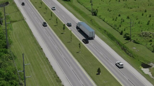 Aerial top down wide view of traffic highways with moving cars and trucks, r