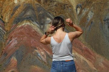 Tourists pose against the background of Martian landscapes – a red deserted area with canyons.