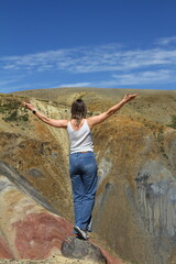 Naklejka premium Tourists pose against the background of Martian landscapes – a red deserted area with canyons.