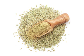 A wooden scoop filled with organic Fennel Seeds (Foeniculum vulgare) Badi saunf powder, placed over a heap of Fennel Seeds, isolated on a white background.