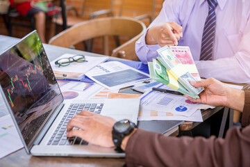 Businesswoman holding money banknotes and making decision for business investment. Selected focus