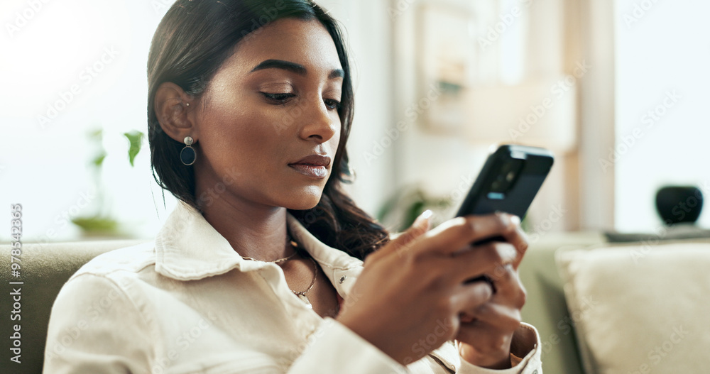 Poster app, phone and serious indian woman on sofa in living room of home for communication or research. in