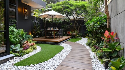 Naklejka premium Wooden path leading to outdoor dining set in backyard garden