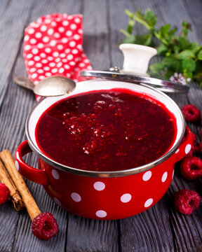raspberry jam in red metal bowl
