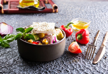 Greek salad with tomatoes, feta cheese, cucumbers, onions and olives