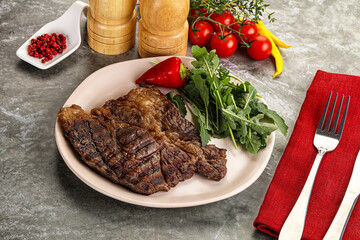 Grilled chuck roll steak with arugula
