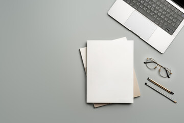 Organized Workspace Featuring Laptop and Blank Paper at Desk in Natural Light