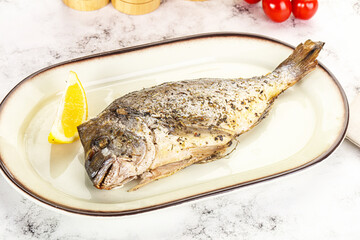 Baked Dorado fish served lemon