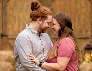 Fototapeta premium Couple smiling at one another in an embrace