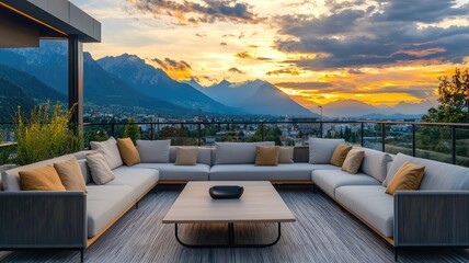 Fototapeta premium A modern outdoor lounge area featuring a cozy sectional sofa, coffee table, and stunning mountain sunset backdrop.
