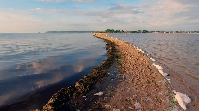 Attractive summer seascape of Baltic sea with the end of the sandbar. Colorful endless clouds  in colorful sky. Amazing morning scene of Rewa public beach, Poland. 4K video (Ultra High Definition).
