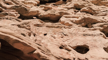 texture of orange stone rock in a colored canyon close up