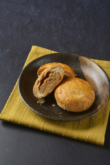 traditional baked teo chew chinese golden yellow mooncake lotus paste bean mooncake with 3d shape flower in black table lantern pastry autumn festival halal asian dessert food menu cafe