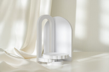 Modern Minimalist White Sculpture Displayed on Soft Draped Fabric in Natural Light