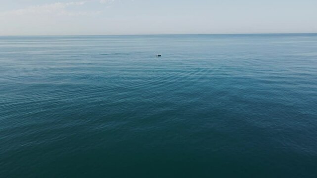 Upward pan shot of a fishing boat on the Tyrrhenian Sea in Italy.